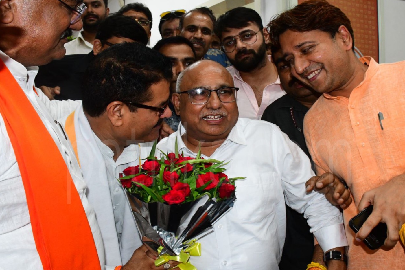 Hemant Khandelwal surrounded by supporters presenting flowers