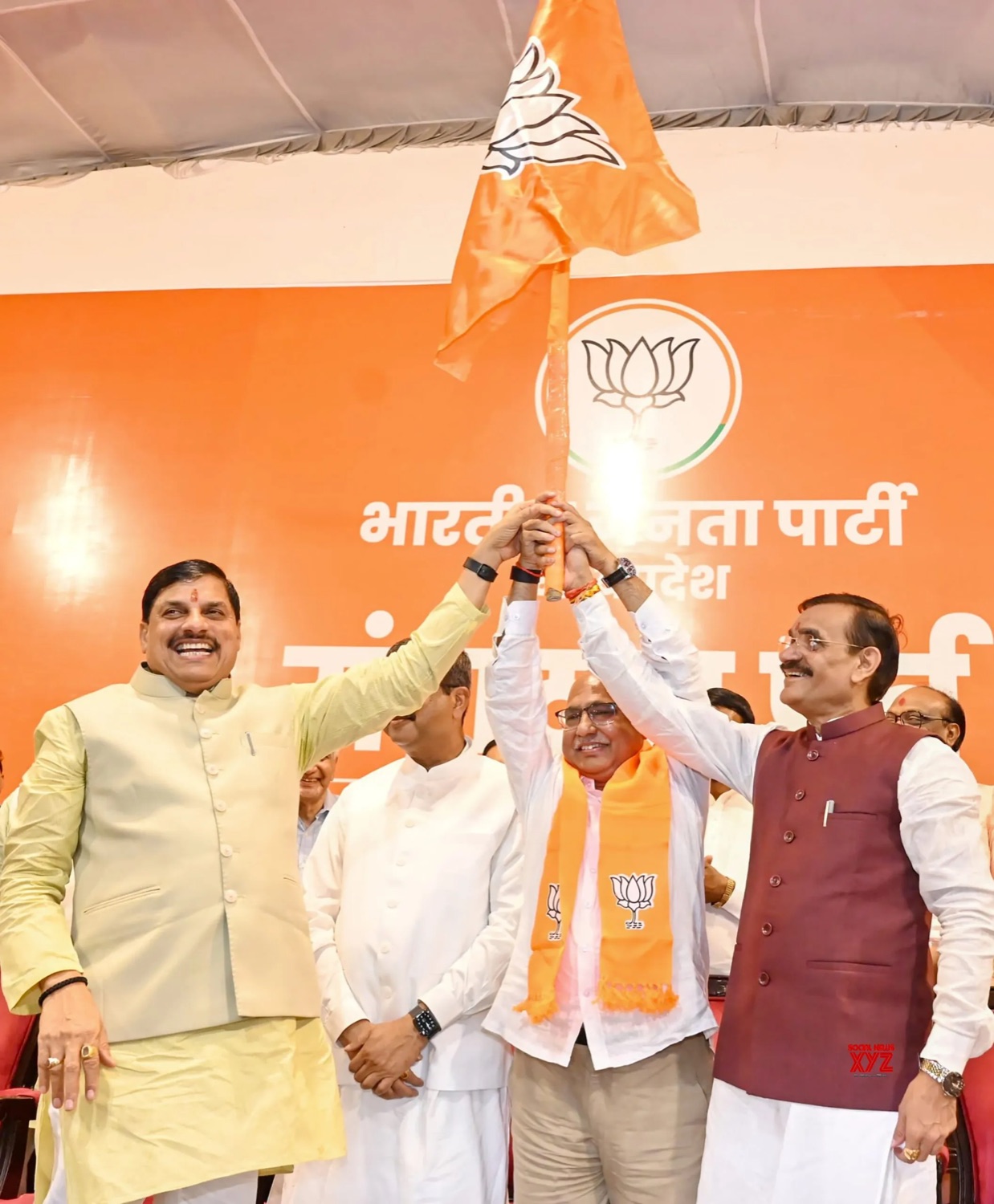 Hemant Khandelwal receiving the party flag on stage at the state headquarters